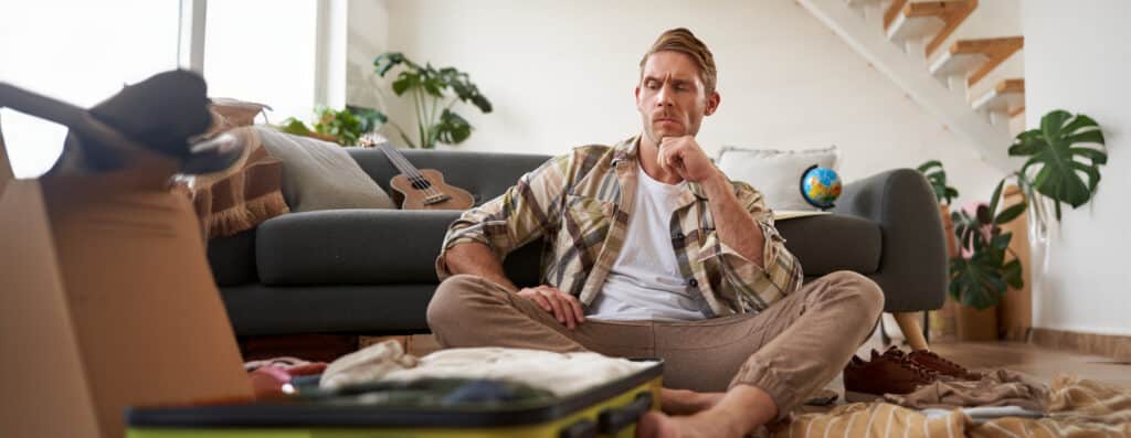 person sitting on couch wondering if he can continue living at home during a repipe in houston tx
