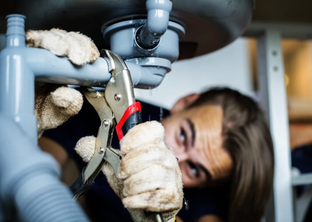 plumber from repipe solutions in houston fixing an emergency leak