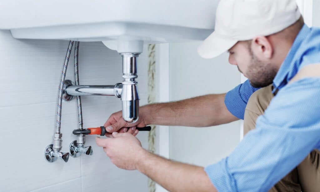 plumber working on house pipes in houston tx