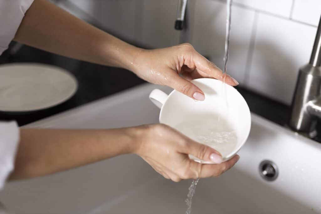 person filling bowl wondering why their water tastes metallic in houston tx