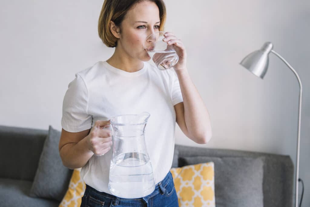 woman in her houston home wondering why her water tastes like plastic after pex pipes were installed