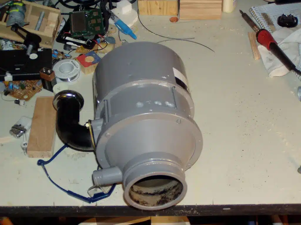 A garbage disposal unit removed from under the sink