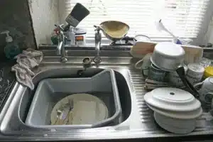 Kitchen sink filled with dirty dishes