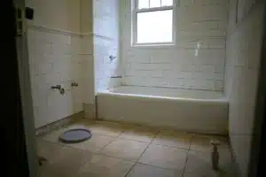 Open tiled shower floor with a floor drain and no curb
