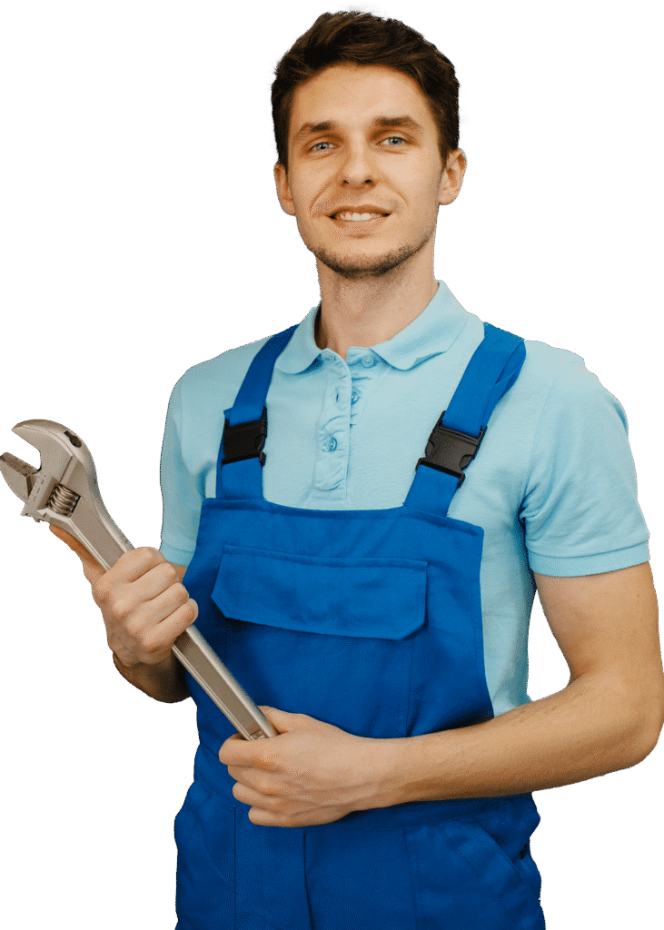 Plumber in blue overalls holding a pipe wrench
